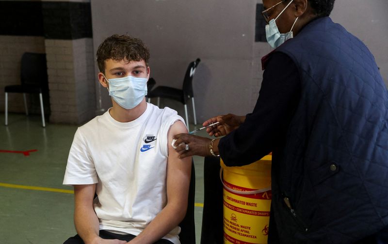 FILE PHOTO: A healthcare worker administers a dose of the Pfizer coronavirus disease (COVID-19) vaccine to a teenager, amidst the spread of the SARS-CoV-2 variant Omicron, in Johannesburg