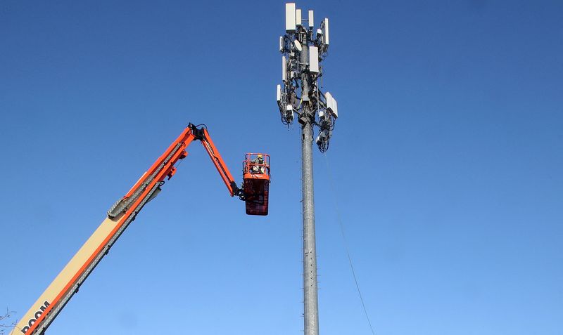 FILE PHOTO: A contract crew from Verizon installs 5G equipment on a tower in Orem