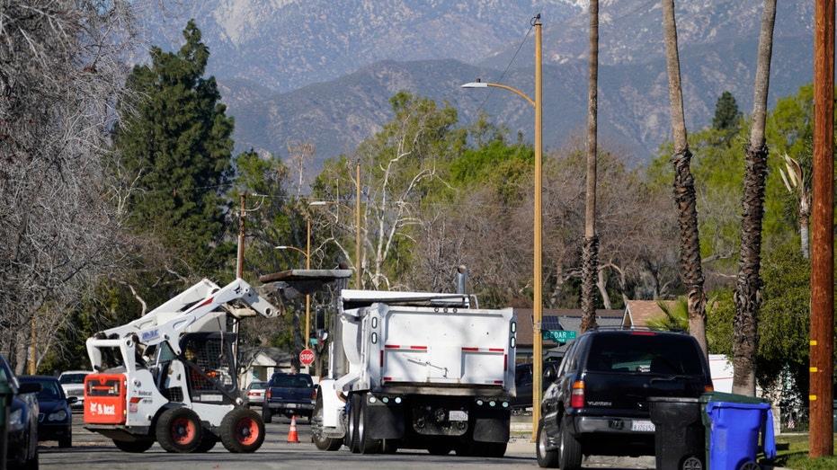 Crews remove damaged concrete sidewalks