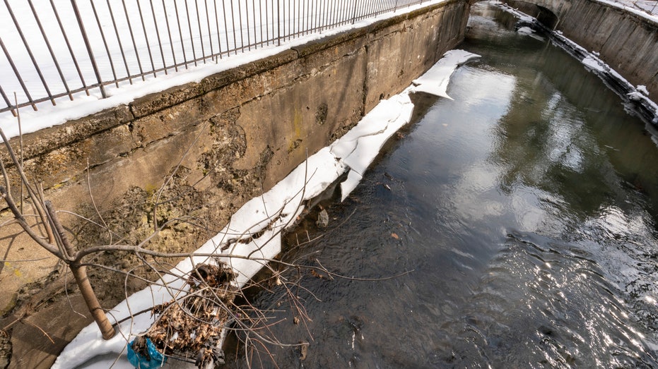 The Fall Kill Creek runs past an eroding retainer wall