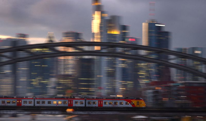 FILE PHOTO: A commuter train passes the skyline in a slow shutter speed photograph in Frankfurt