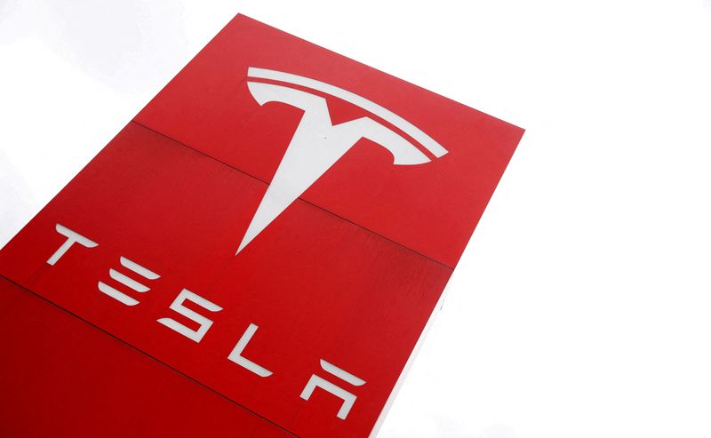 FILE PHOTO: FILE PHOTO: The logo of car manufacturer Tesla is seen at a dealership in London