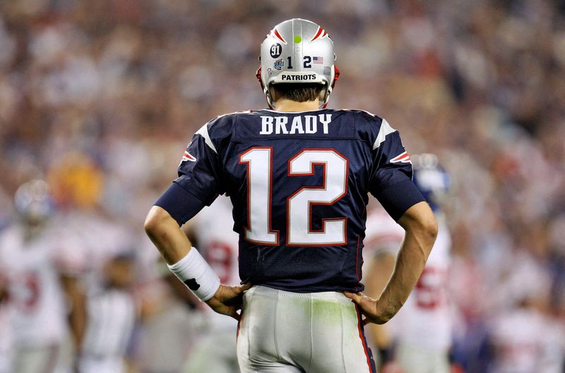 FILE PHOTO: New England Patriots quarterback Tom Brady watches the New York Giants celebrate in Glendale