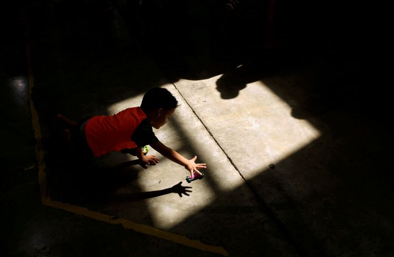 FILE PHOTO: A migrant boy, who returned to Mexico with his parents from the U.S. under the Migrant Protection Protocols, plays at a migrant shelter run by the federal government in Ciudad Juarez