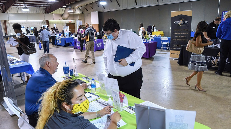 People seeking employment attend the 25th annual Central Florida Employment Council Job Fair at the Central Florida Fairgrounds on May 12, 2021.