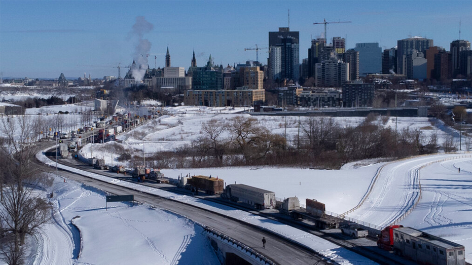 Vehicles of the protest convoy are seen parked on the Sir John A. Macdonald parkway leading in to downtown Ottawa on Sunday, Jan. 30, 2022.