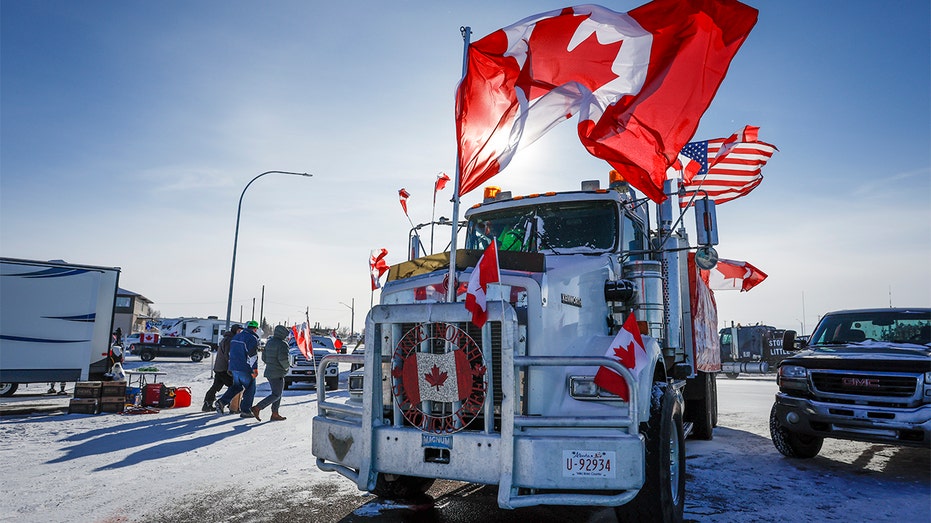 The last truck blocking the southbound lane moves after a breakthrough resolved the impasse where anti-COVID-19 vaccine mandate demonstrators blocked the highway at the busy U.S. border crossing in Coutts, Alberta, Wednesday, Feb. 2, 2022.