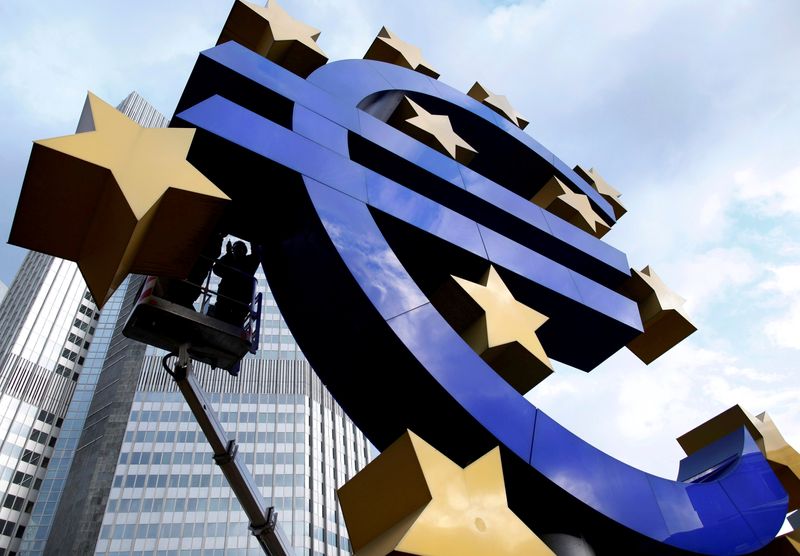 FILE PHOTO: Workers maintain the huge Euro logo in front headquarters of ECB in Frankfurt