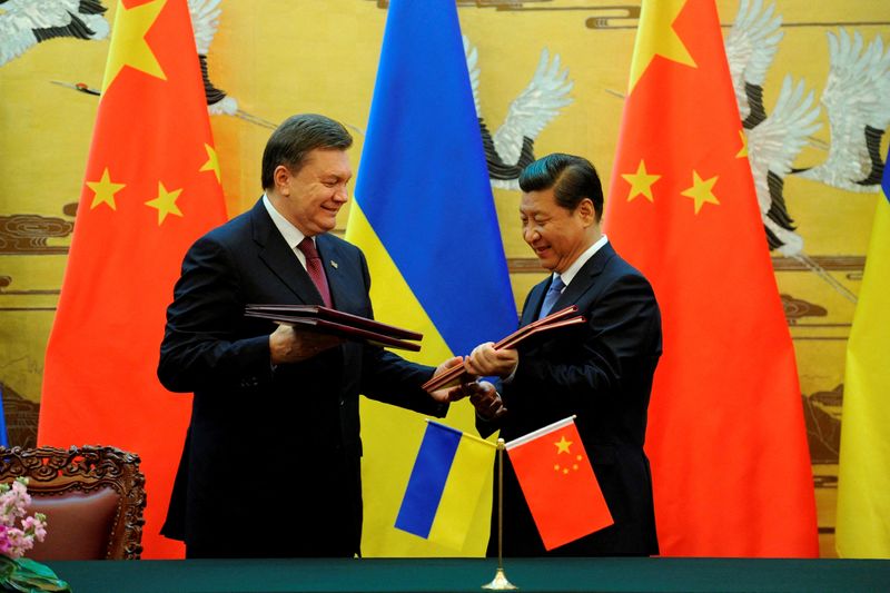 FILE PHOTO: Ukraine's then president Yanukovich and Chinese President Xi exchange documents during a signing ceremony in Beijing