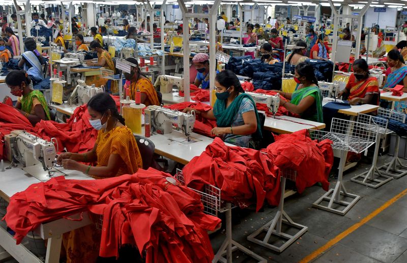 Garment workers stitch shirts at a textile factory of Texport Industries in Hindupur