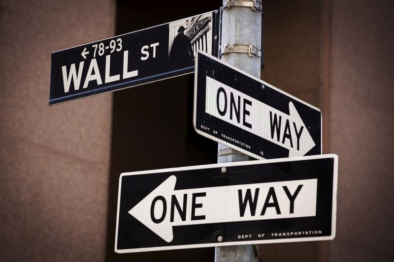 FILE PHOTO: A 'Wall St' sign is seen above two 'One Way' signs in New York