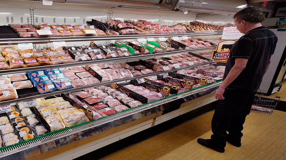 A man looks at beef in the meat department at Lambert's Rainbow Market on June 15, 2021, in Westwood, Massachussetts. 