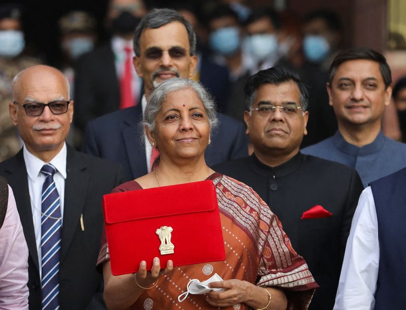 India's Finance Minister Nirmala Sitharaman holds up a folder with the Government of India’s logo