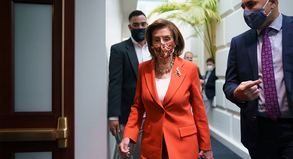 Speaker of the House Nancy Pelosi, D-Calif., arrives to meet with the Democratic Caucus at the Capitol in Washington early Tuesday, Nov. 2, 2021. 