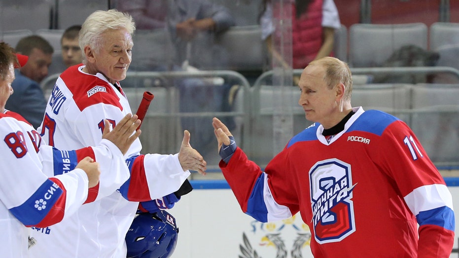 Russian President Vladimir Putin (R) greets billionaire and businessman Gennady Timchenko (L) during a group photo at the gala match of the Night Hockey League at Bolshoi Ice Dome on May 10, 2019, in Sochi, Russia. Putin scored 10 goals, and his team the Hockey Stars won 14:7 in this match against the Night Hockey League team. 