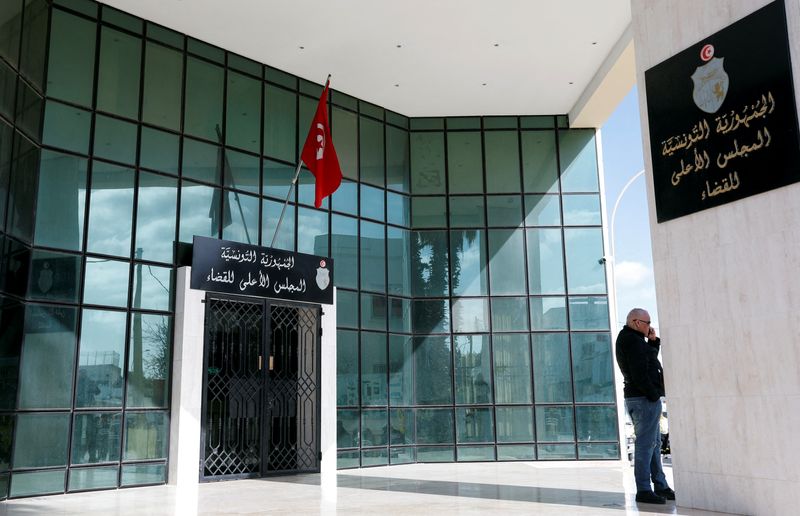 FILE PHOTO: Man stands outside the Supreme Judicial Council building in Tunis