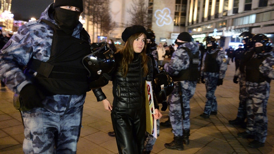 Police detain a demonstrator during an action against Russia's attack on Ukraine in Moscow, Russia, Saturday, Feb. 26, 2022. Protests against the Russian invasion of Ukraine resumed on Saturday evening, with people taking to the streets of Moscow and St. Petersburg for the third straight day despite mass arrests. OVD-Info rights group reported that at least 325 people were detained in 26 Russian cities on Saturday in antiwar protests, nearly half of them in Moscow. (AP Photo/Denis Kaminev)