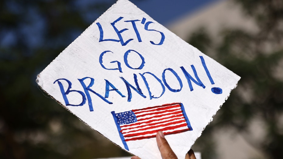 A protestor holds a 'Let's Go Brandon!' sign in Grand Park at a ‘March for Freedom’ rally demonstrating against the L.A. City Council’s COVID-19 vaccine mandate for city employees and contractors on November 8, 2021 in Los Angeles, California. The City Council has set a deadline of December 18 for all city employees and contractors to be vaccinated except for those who have religious or medical exemptions. (Photo by Mario Tama/Getty Images)