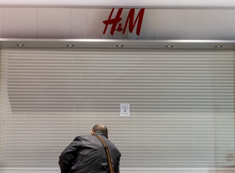 FILE PHOTO: A man looks at a closed H&M store in a shopping mall in Moscow