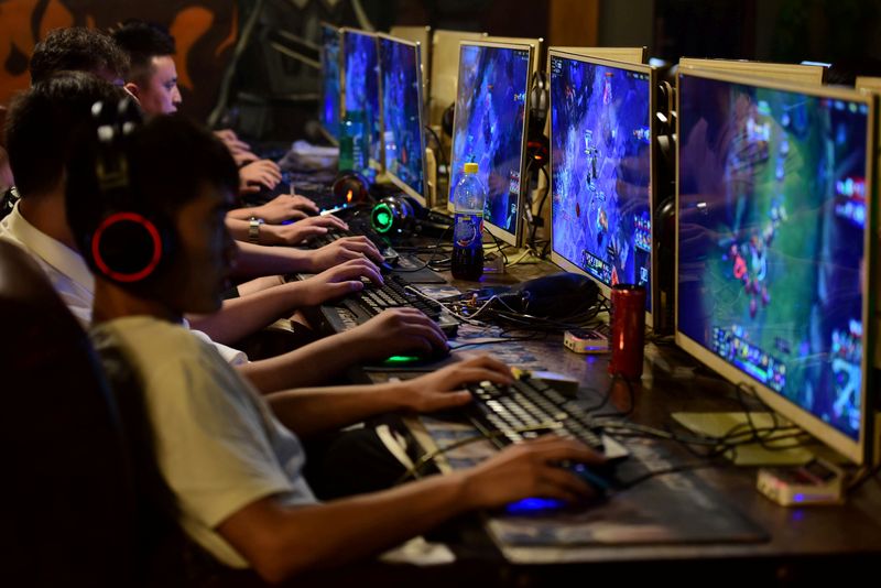 FILE PHOTO: People play online games at an internet cafe in Fuyang