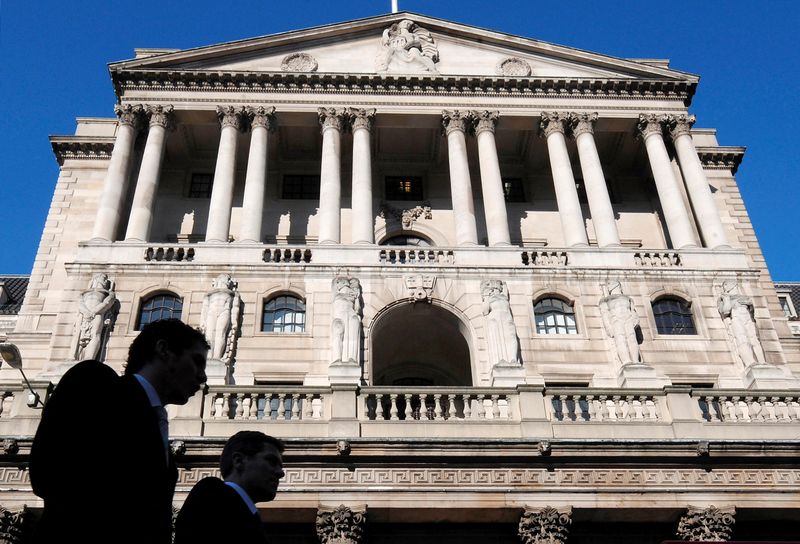 FILE PHOTO: City workers walk past the Bank of England in London