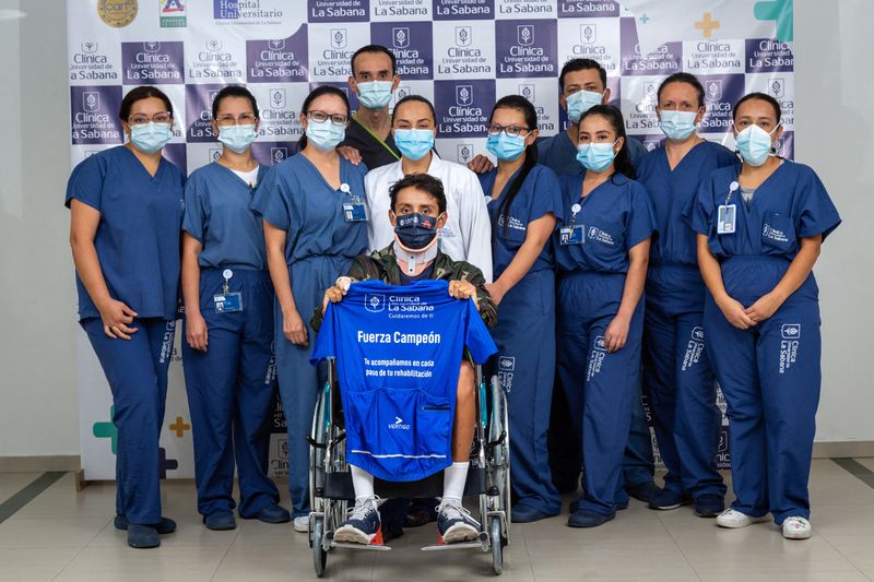 Former Tour de France winner Egan Bernal poses for a photo with the medical team of the Clinica Universidad de la Sabana, in Chia