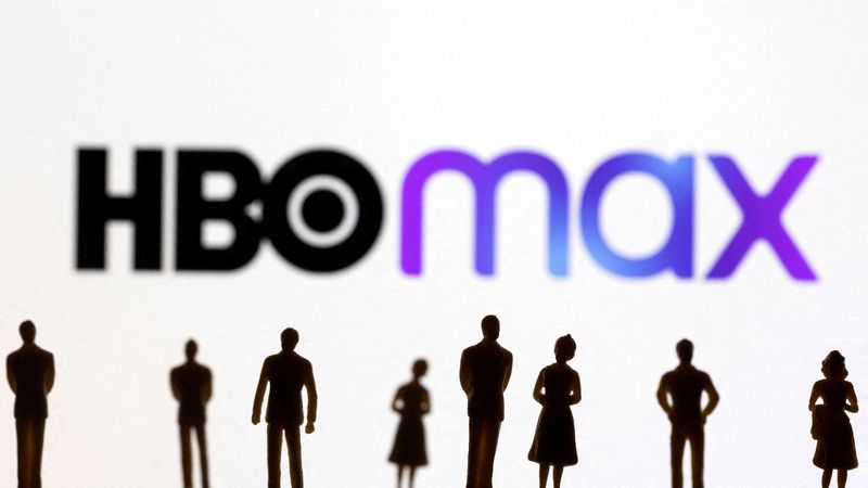 FILE PHOTO: Toy figures of people are seen in front of the displayed HBO Max logo, in this illustration