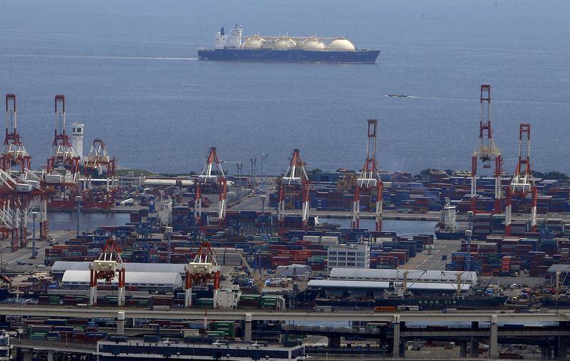 FILE PHOTO: A LNG tanker is seen behind a port in Yokohama