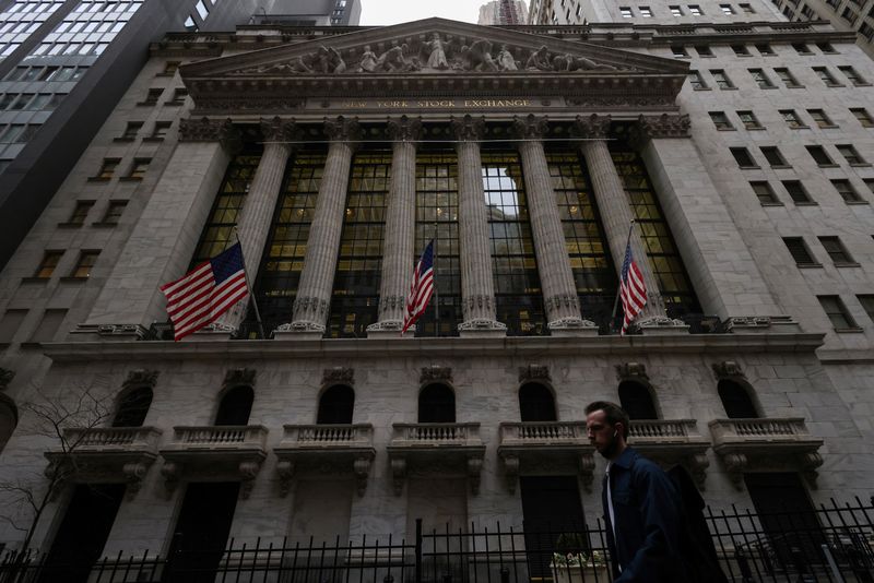 A person walks past the New York Stock Exchange (NYSE) in Manhattan, New York City