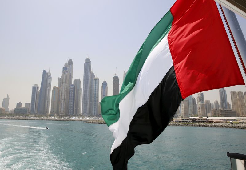 FILE PHOTO: UAE flag flies over a boat at Dubai Marina,