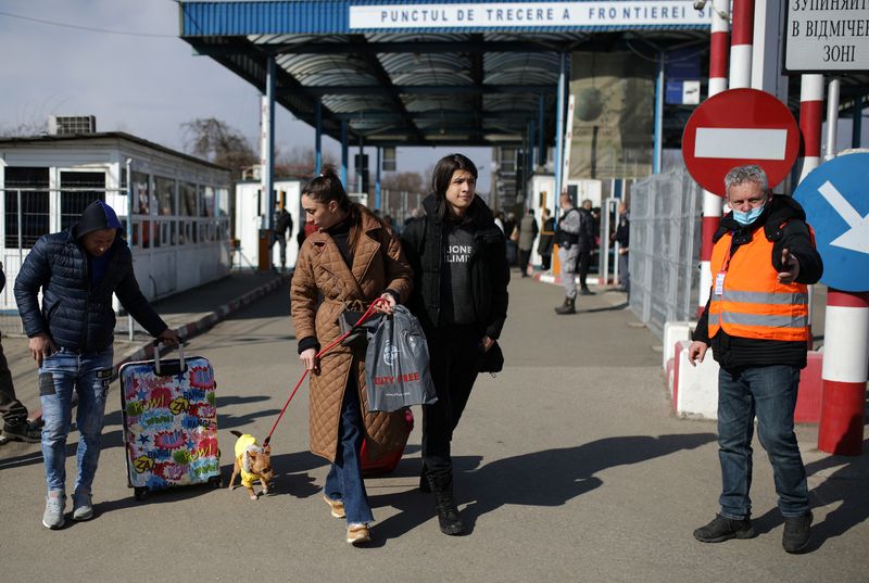 People flee from Ukraine to Romania at the border crossing, in Sighetu Marmatiei