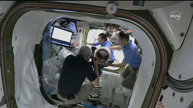 Spacewalkers carry out repairs and maintenance