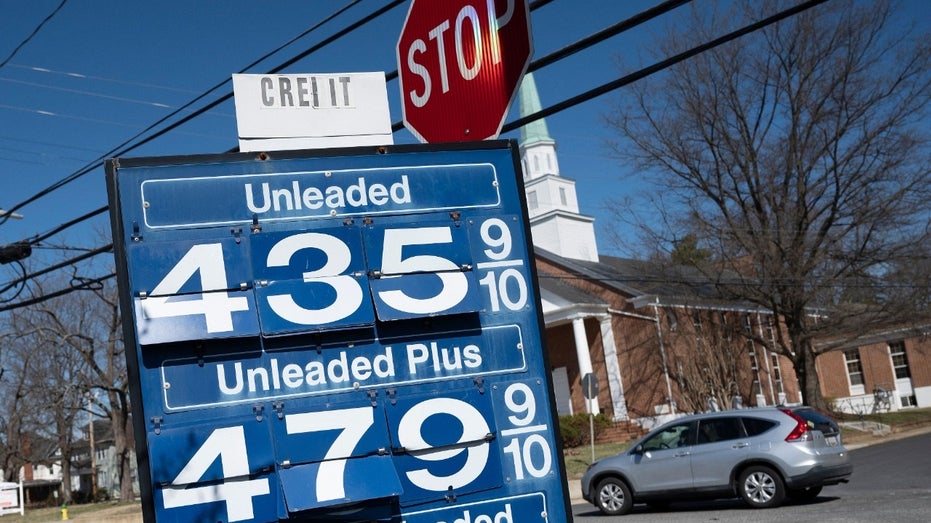 A car passes a gas station sign in Annapolis, Maryland, on March 14, 2022