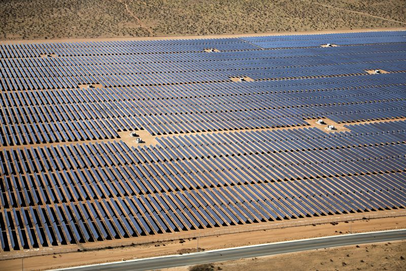 An array of solar panels is seen in the desert near Victorville