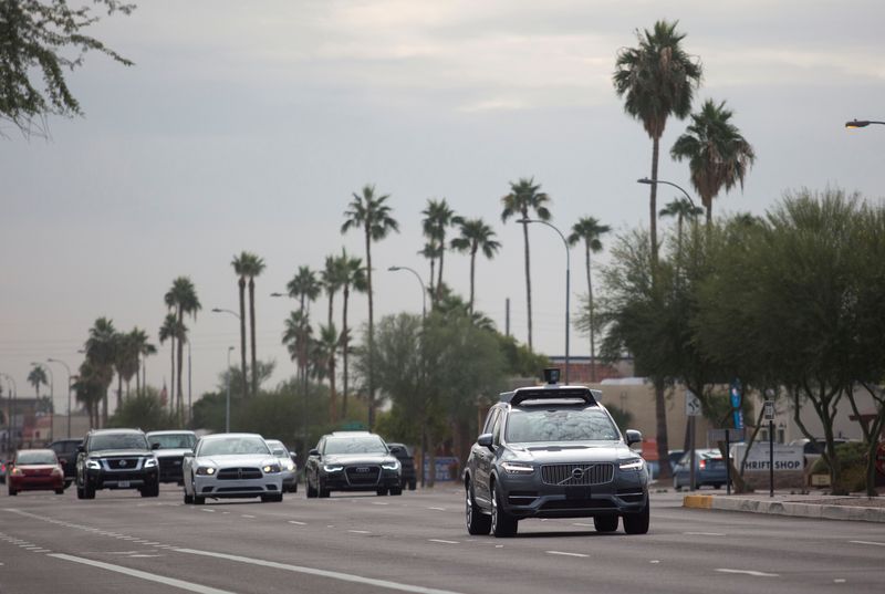 FILE PHOTO: A self driving Volvo vehicle moves along the streets of Scottsdale, Arizona