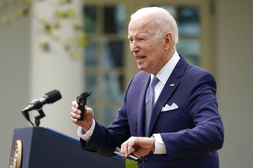 President Joe Biden holds pieces of a 9mm pistol as he speaks in the Rose Garden of the White House in Washington, Monday, April 11, 2022. Biden announced a final version of the administration’s ghost gun rule, which comes with the White House and the Justice Department under growing pressure to crack down on gun deaths. (AP Photo/Carolyn Kaster)