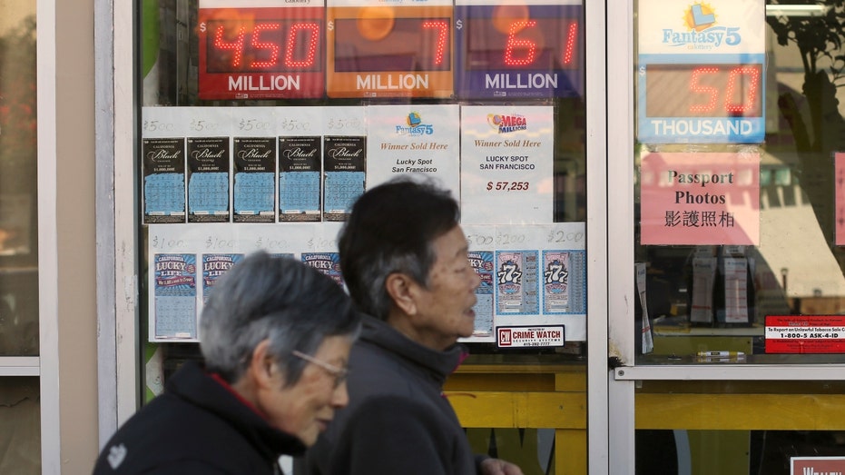 Pedestrians walk by a store selling scratchers and Powerball tickets in San Francisco