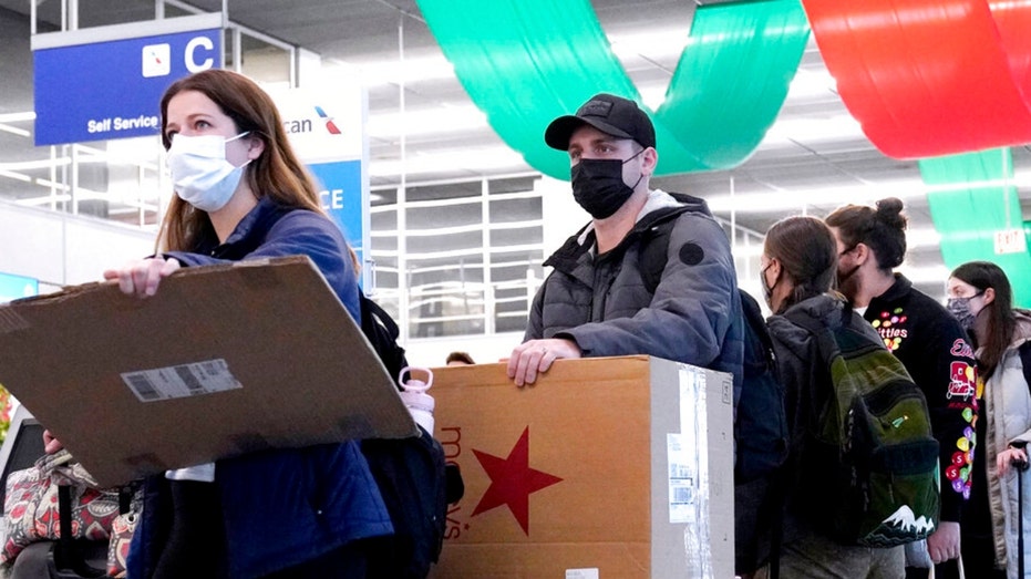 Travelers wearing protective masks indoors at O'Hare International Airport