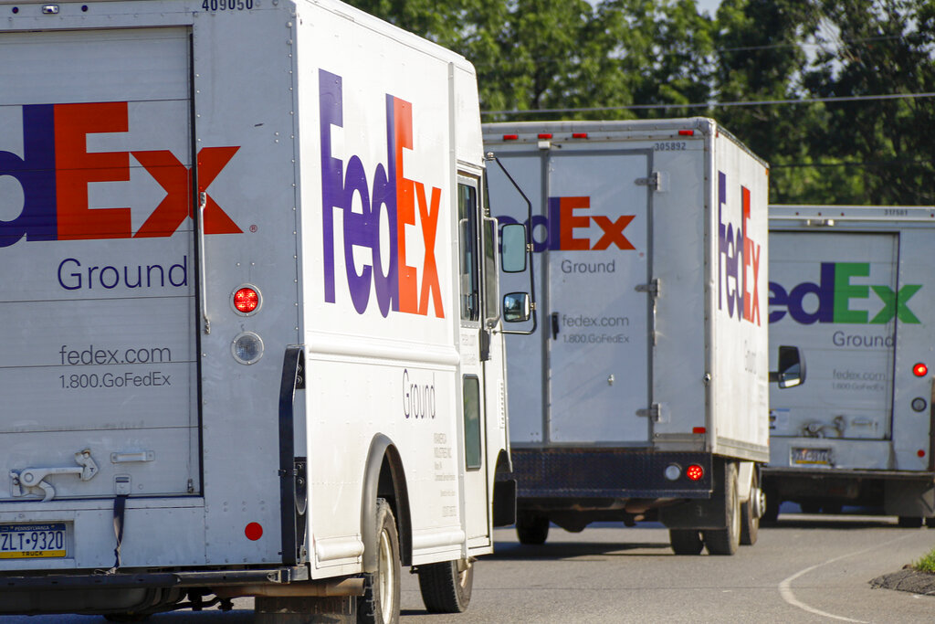 FILE - Delivery vehicles depart the FedEx Ship Center in Cranberry Township, Pa., on June 26, 2019. Shipping giant FedEx Corp. says its logistics subsidiary has opened a new global headquarters in downtown Memphis, Tenn. FedEx Logistics says it held an event Tuesday, April 5, 2022, to mark the opening of its offices in the former Gibson guitar factory, just steps from historic Beale Street and the FedExForum sports and concert venue in Memphis. (AP Photo/Keith Srakocic, File)
