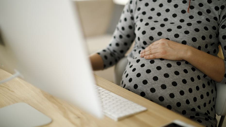 Pregnant worker on laptop
