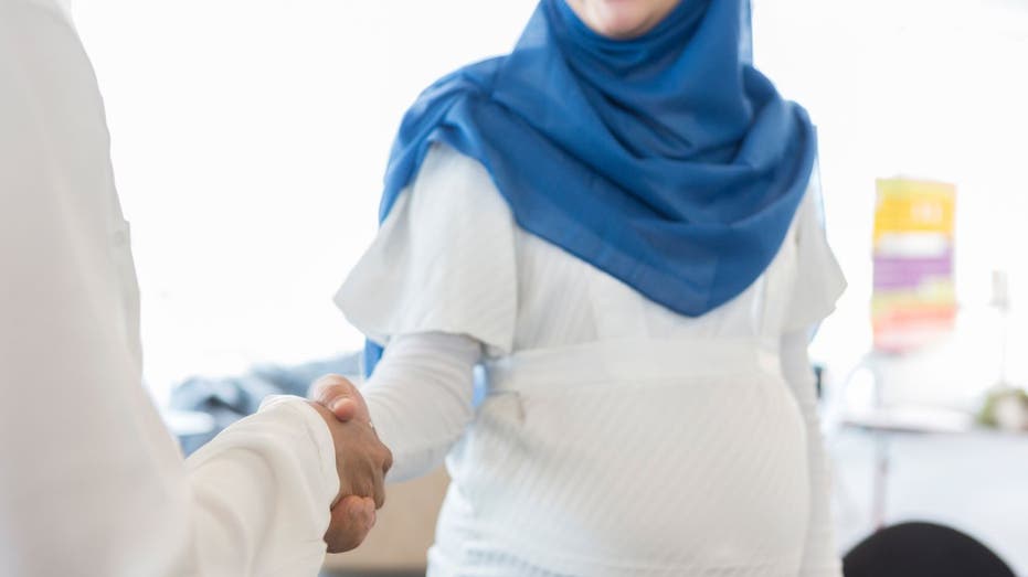 Pregnant woman shaking hands