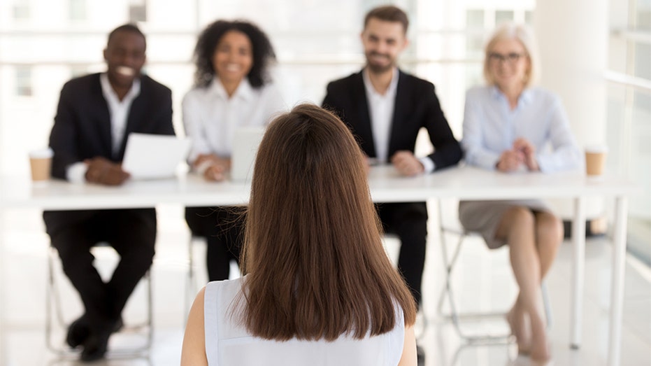Woman sits in job interview room