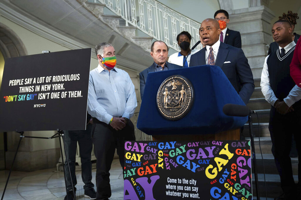 New York Mayor Eric Adams, at podium, addresses a news conference in the rotunda of City Hall, in New York, Monday, April 4, 2022. New York City is launching a digital billboard campaign, supporting LGBTQ visibility that will be displayed in five major markets in Florida for eight weeks, to lure Floridians unhappy with their state's "Don't Say Gay" law to the Big Apple, Adams announced. (Ed Reed/Office of the New York City Mayor via AP)