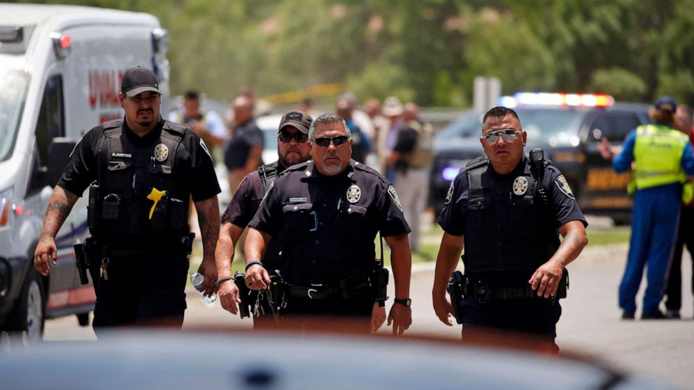 PHOTO: Police walk near Robb Elementary School following a shooting, May 24, 2022, in Uvalde, Texas.