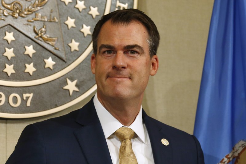 Oklahoma Gov. Kevin Stitt smiles at a news conference in Oklahoma City. Stitt is requesting an additional $300 in federal unemployment benefits for Oklahomans who have lost their jobs. (AP Photo/Sue Ogrocki, File)