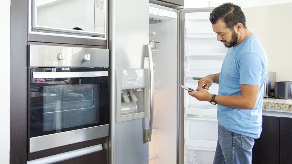 man shops for fridge