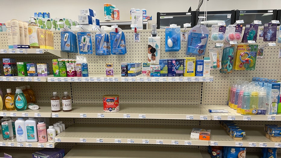 Grocery and pharmacy store shelves empty with baby formula at a premium