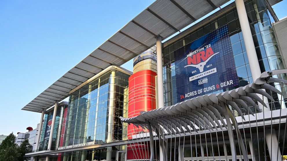 PHOTO: The George R. Brown convention center in downtown Houston, is seen with an NRA banner advertising 14 acres of guns and gear for the Houston'22 National Rifle Association convention, on May 25, 2022.
