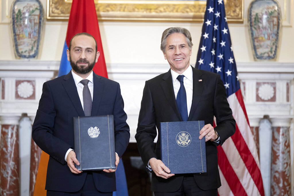 Armenia's Foreign Minister Ararat Mirzoyan and Secretary of State Antony Blinken hold up their documents during a signing ceremony at the State Dept, Monday, May 2, 2022, in Washington. Blinken and Mirzoyan signed a Memorandum of Understanding Concerning Strategic Civil Nuclear Cooperation. (Brendan Smialowski/Pool photo via AP)