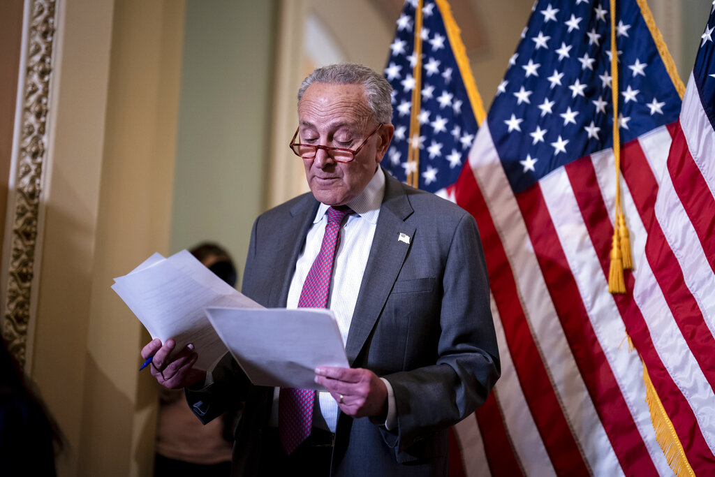 Senate Majority Leader Chuck Schumer, D-N.Y., looks over his notes before speaking to reporters at a news conference following a closed-door policy lunch, at the Capitol in Washington, Tuesday, May 24, 2022. (AP Photo/J. Scott Applewhite)